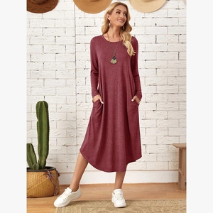Detail view of burgundy long sleeve dress showing side pockets and curved hem
