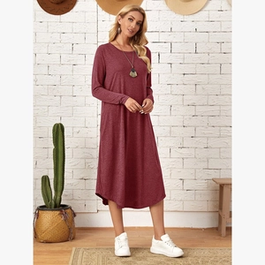 Detail of loose wine red knit dress featuring side pockets and a curved hem design