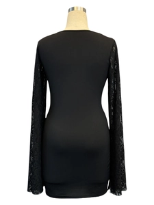 Detailed back view of bodycon dress showing black lace sleeves with floral patterns