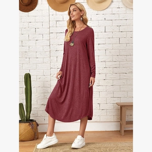 Detail view of burgundy knit dress fabric and side pocket on long sleeve midi dress