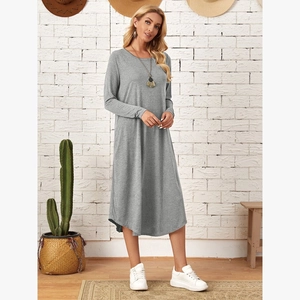Detail view of the side-seam pockets and curved hemline on a loose gray knit midi dress