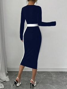 Rear view detail of slim fit long sleeve midi dress with navy and white color block panels