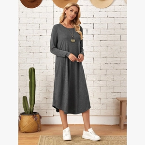 Detailed macro view of the dark grey knitted long sleeve dress fabric and curved hemline