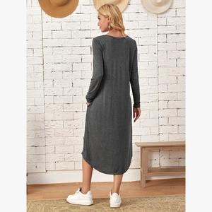 Detail of dark grey knit dress featuring side pockets and an elegant curved hemline