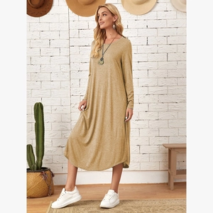 Detail shot of khaki knit dress side pocket and curved hemline on soft fabric