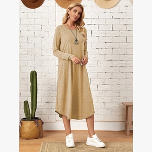 Detail of oatmeal knit dress featuring side pockets and curved high-low hemline