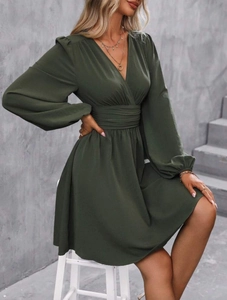 Close-up of deep green V-neck dress featuring elegant lantern sleeves and waist cinching