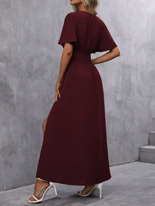 Détail de la robe longue bordeaux avec manches volantées et fente haute sur la jambe