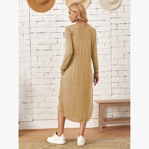 Detail of the mustard yellow knit dress showing curved hemline and side pocket design