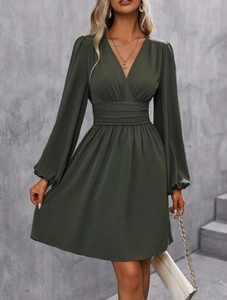Detail view of olive green V-neck mini dress with lantern sleeves and pleated waist