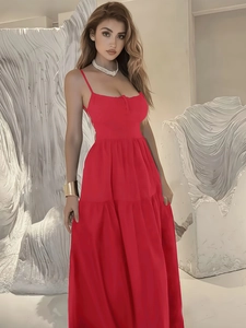 Detail of red backless halter maxi dress with layered ruffle hem and waist tie design