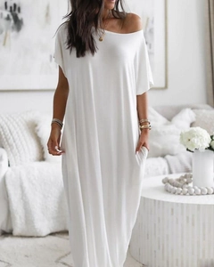 Detail of white maxi dress showing soft cotton fabric texture and handy side pockets