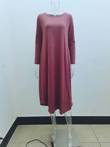Detail of the reddish-brown knit fabric and side pockets on a long sleeve dress