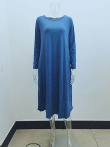 Detail view of the soft knit fabric texture and side-seam pockets on this blue dress