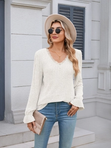 Close-up of cream ribbed top featuring delicate lace V-neckline and bell sleeve details
