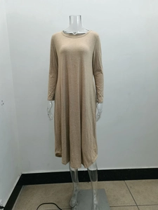 Close-up of beige knit fabric texture and side pocket detail on long sleeve dress
