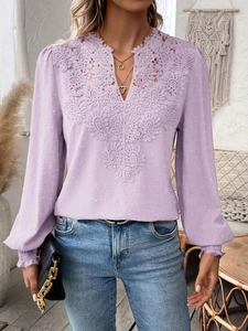 Detail of lavender V-neck top showing lace patchwork and delicate Swiss dot fabric texture