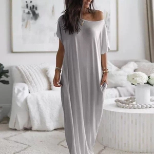 Detail view of a loose grey maxi dress with drop shoulders and functional side pockets