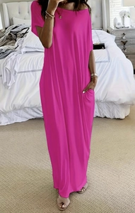 Close-up of a loose fit rose red maxi dress showing side pockets and soft cotton fabric
