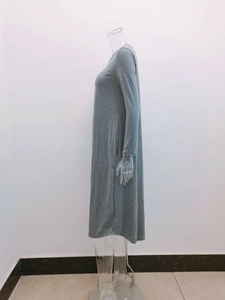 Detailed side view showing knit texture and curved hem of grey long sleeve dress