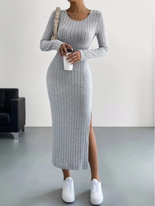 Detail of grey ribbed knit maxi dress showing side slit and vertical texture