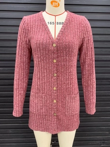 Detail shot of the ribbed texture and wooden buttons on the pink long-sleeve cardigan