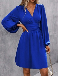Detail of royal blue V-neck dress featuring lantern sleeves and a wrap waist design