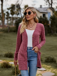Detail of mauve ribbed knit cardigan featuring vintage wooden buttons and side pockets