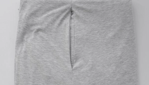 Close-up of side seam pockets and gray knit texture on long sleeve dress