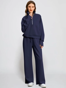 Women's dark blue two-piece lounge set with half-zip sweatshirt and wide-leg trousers