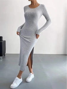Detail showing the ribbed texture and high side slit of a light gray knitted maxi dress