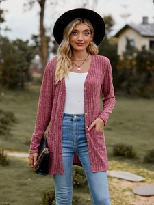 Detail of dusty rose ribbed knit cardigan featuring front buttons and side pockets