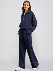 Women's dark blue two-piece lounge set with high neck zip hoodie and wide-leg knit pants