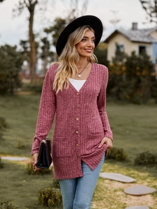 Detail of rose pink ribbed knit cardigan featuring V-neck buttons and two front pockets