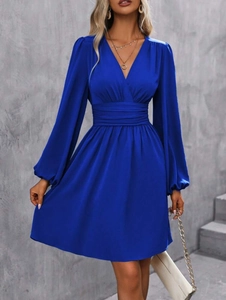Detail of royal blue V-neck dress with wrap-style top and pleated high waist design