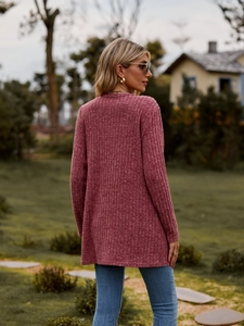 Detail of dusty pink knit cardigan with vertical ribbed texture and mid-length casual style