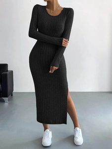 Detail view of dark grey knitted dress showing the side slit and vertical ribbed texture