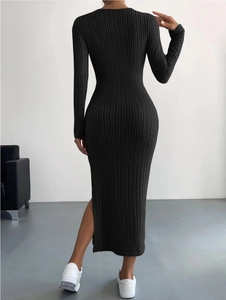Detail view of the high side slit on this black ribbed knit maxi dress from the back