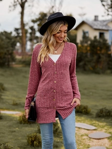 Outdoor detail of women's rose pink ribbed knit cardigan with V-neck and front pockets
