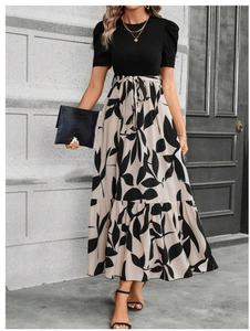Detail of elegant black puff sleeves and high-waist floral print skirt with a bow tie