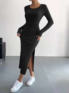 Detail of black long sleeve ribbed knit maxi dress featuring a stylish side slit design