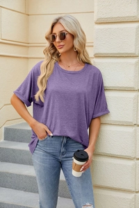 Detail view of a loose purple crewneck T-shirt with rolled sleeves and cotton texture