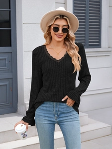 Detail of V-neck lace trim and ribbed texture on this black long sleeve casual knit top