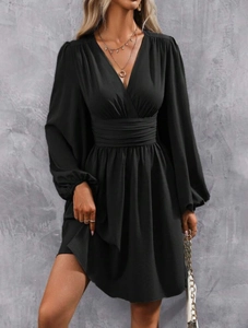 Detail of elegant black V-neck mini dress showing ruched waist and puffed lantern sleeves