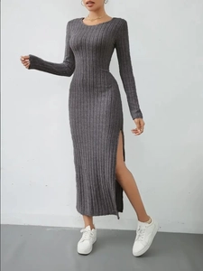 Detail view of the vertical ribbed texture and side slit of the grey knit midi dress