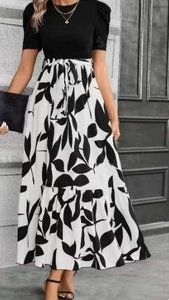 Detail of high-waist floral print A-line skirt with puff sleeves and tie waist