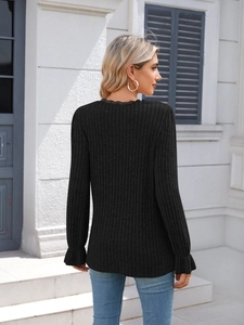 Detail of ribbed long sleeve top with lace trim collar and ruffled cuffs in black