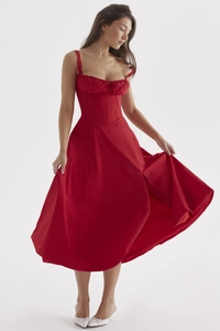Detail of red sleeveless midi dress featuring pleated bust and high slit flare skirt
