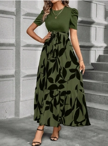 Detail of green floral dress featuring a high waist drawstring and ruffled hemline