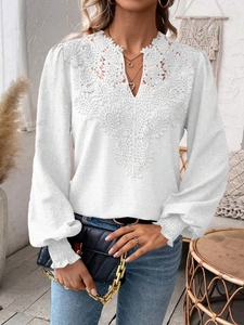 Detail of V-neck lace trim and Swiss dot fabric on this elegant white long sleeve top